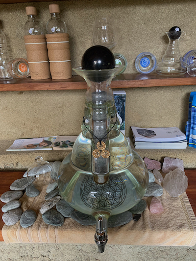 10L Unbiverse Carafe topped by gleaming 90mm shungite sphere, filled with paramagnetic earth resonance blend and draped with gold-plated 3 spiral triskelion